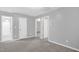 Second floor bedroom featuring neutral paint, carpet, and multiple doorways to other rooms at 1305 Montreux Ct, Mebane, NC 27302