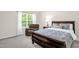A sun-filled bedroom features natural lighting and a comfortable chair at 1305 Montreux Ct, Mebane, NC 27302
