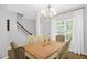 Bright dining area with large table and chairs, next to the staircase at 1305 Montreux Ct, Mebane, NC 27302