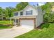 Charming two-story home boasts a two-car garage, manicured lawn and a welcoming front porch at 1305 Montreux Ct, Mebane, NC 27302
