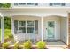 Inviting front porch with classic rocking chairs and colorful landscaping enhance the curb appeal at 1305 Montreux Ct, Mebane, NC 27302