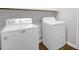Bright laundry room featuring a white, front-load washing machine and dryer at 1305 Montreux Ct, Mebane, NC 27302