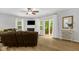 Comfortable living room with a fireplace, ceiling fan, and sliding door to the outdoors at 1305 Montreux Ct, Mebane, NC 27302
