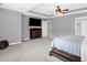 Spacious main bedroom featuring a ceiling fan, large dresser, and a door to the ensuite bathroom at 1305 Montreux Ct, Mebane, NC 27302