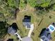 Aerial view of a home with a long driveway, landscaping, and surrounded by mature trees at 140 Barletta Ct, Clayton, NC 27527