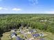 A bird's eye view showcasing homes in the neighborhood surrounded by beautiful lush green forests at 140 Barletta Ct, Clayton, NC 27527