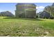 A large backyard with plenty of space for recreation and a view of the home's deck and upper floors at 140 Barletta Ct, Clayton, NC 27527