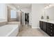 Spacious bathroom featuring a soaking tub, glass-enclosed shower, and double vanity at 140 Barletta Ct, Clayton, NC 27527