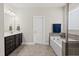 Bathroom with dark vanity, tiled floors and large tub at 140 Barletta Ct, Clayton, NC 27527