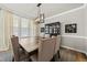 Elegant dining room with a modern light fixture and seating for six at 140 Barletta Ct, Clayton, NC 27527