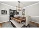 Bright dining room with wood table, bench seating, elegant chandelier, and stylish black hutch at 140 Barletta Ct, Clayton, NC 27527