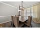 Dining room with wooden table, upholstered chairs, modern chandelier, and bright natural light at 140 Barletta Ct, Clayton, NC 27527