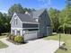 Beautiful two-story home featuring a well-manicured lawn, gray siding, and a spacious two-car garage with basketball hoop at 140 Barletta Ct, Clayton, NC 27527