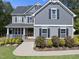 Charming two-story home featuring a covered front porch, manicured landscaping, and classic architectural details at 140 Barletta Ct, Clayton, NC 27527