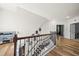 Open hallway with gleaming hardwood floors, natural light, and easy access to all areas of the home at 140 Barletta Ct, Clayton, NC 27527