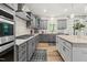 Beautiful kitchen with gray cabinetry, granite countertops, and stainless steel appliances at 140 Barletta Ct, Clayton, NC 27527