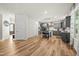 Open concept kitchen with hardwood floors, gray cabinets, island seating, and backyard access at 140 Barletta Ct, Clayton, NC 27527