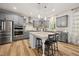 Modern kitchen features gray cabinets, stainless steel appliances, and a large center island with seating at 140 Barletta Ct, Clayton, NC 27527