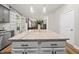 Close up of white kitchen island with granite countertop and view into the living room at 140 Barletta Ct, Clayton, NC 27527