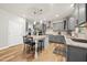 Bright kitchen with island seating, stainless steel appliances, stylish cabinets, and hardwood flooring at 140 Barletta Ct, Clayton, NC 27527