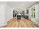 Open kitchen with stainless steel appliances, gray cabinets, island seating, and bright natural light at 140 Barletta Ct, Clayton, NC 27527