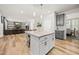 Open concept kitchen with island, granite countertops and view into the living room with fireplace at 140 Barletta Ct, Clayton, NC 27527