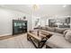 Inviting living room with plush sofa, patterned rug, modern hutch, and open access to kitchen at 140 Barletta Ct, Clayton, NC 27527