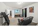 Bright living room with large TV and comfortable seating with access to hallway at 140 Barletta Ct, Clayton, NC 27527