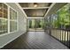 Inviting screened porch featuring wood flooring, paneled ceiling, and serene views of the lush backyard at 140 Barletta Ct, Clayton, NC 27527