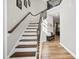 Inviting staircase with wood treads, white risers, and decorative wrought iron balusters at 140 Barletta Ct, Clayton, NC 27527