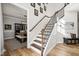 Elegant staircase with hardwood treads, iron spindles, and natural light at 140 Barletta Ct, Clayton, NC 27527