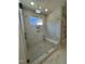 Modern bathroom featuring a glass shower with white marble-style tile, a built-in seat, and double shower heads at 1403 Cottondale Lane, Wake Forest, NC 27587