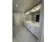 Double vanity bathroom featuring marble floors, a large mirror and modern lights at 1403 Cottondale Lane, Wake Forest, NC 27587