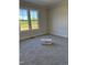 Bedroom with plush carpet, large windows, and ample natural light at 1403 Cottondale Lane, Wake Forest, NC 27587