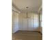 Dining room with elegant chandelier, panelled walls, and detailed trim, offering a sophisticated space for entertaining at 1403 Cottondale Lane, Wake Forest, NC 27587