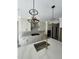 Bright kitchen with modern appliances, white cabinetry, light countertops and stunning globe pendant lighting at 1403 Cottondale Lane, Wake Forest, NC 27587