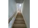 Staircase with modern wood steps, white risers and white walls leads to the upper level at 1403 Cottondale Lane, Wake Forest, NC 27587