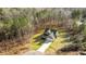 Aerial shot reveals a private home nestled among tall trees, set back on a long driveway, showcasing seclusion and natural beauty at 145 Leisure Ln # 12, Louisburg, NC 27549