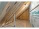 Another shot of the unfinished attic with wooden beams and plywood offering potential for customization and storage at 145 Leisure Ln # 12, Louisburg, NC 27549