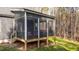 Back exterior view of home showcasing a screened in porch and spacious yard, blending indoor/outdoor enjoyment at 145 Leisure Ln # 12, Louisburg, NC 27549