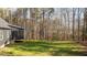 Large backyard view featuring a screened-in porch, and wooded area, perfect for outdoor activities and peaceful surroundings at 145 Leisure Ln # 12, Louisburg, NC 27549
