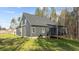 Expansive backyard showcasing the home's siding, windows, and screened porch, perfect for relaxation and entertainment at 145 Leisure Ln # 12, Louisburg, NC 27549