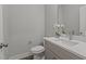 Half bathroom showcasing sleek quartz countertops, contemporary sink fixtures, and a toilet creating a modern design at 145 Leisure Ln # 12, Louisburg, NC 27549