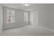Bedroom with natural light from two windows and neutral colored walls and carpet at 145 Leisure Ln # 12, Louisburg, NC 27549