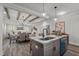 Open concept kitchen and dining area with wood beam ceiling and hardwood floors at 145 Leisure Ln # 12, Louisburg, NC 27549