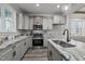 Elegant kitchen featuring granite counters, stainless appliances, and light gray cabinets at 145 Leisure Ln # 12, Louisburg, NC 27549