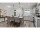 Bright kitchen with island, pendant lighting, light gray cabinets, and exterior access at 145 Leisure Ln # 12, Louisburg, NC 27549