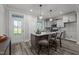 Bright, open kitchen with island, pendant lights, light gray cabinets, and outside access at 145 Leisure Ln # 12, Louisburg, NC 27549