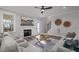 Cozy living room with fireplace, ceiling fan, neutral paint, and access to the stairs at 145 Leisure Ln # 12, Louisburg, NC 27549