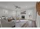 Bright living room with hardwood floors, fireplace, and access to an outdoor deck at 145 Leisure Ln # 12, Louisburg, NC 27549
